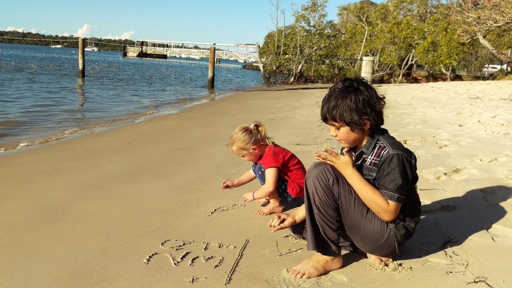 Markito doing some maths and Freyja drawing with sticks on the beach at Karragarra Island. 15 July 2017