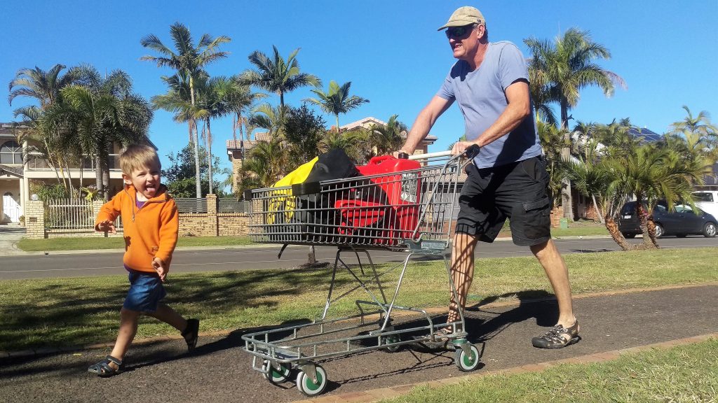 Simon pushing the shopping trolley that's carrying our heavy jerry cans full of petrol. Zach providing encouragement and entertainment. 21 July 2017