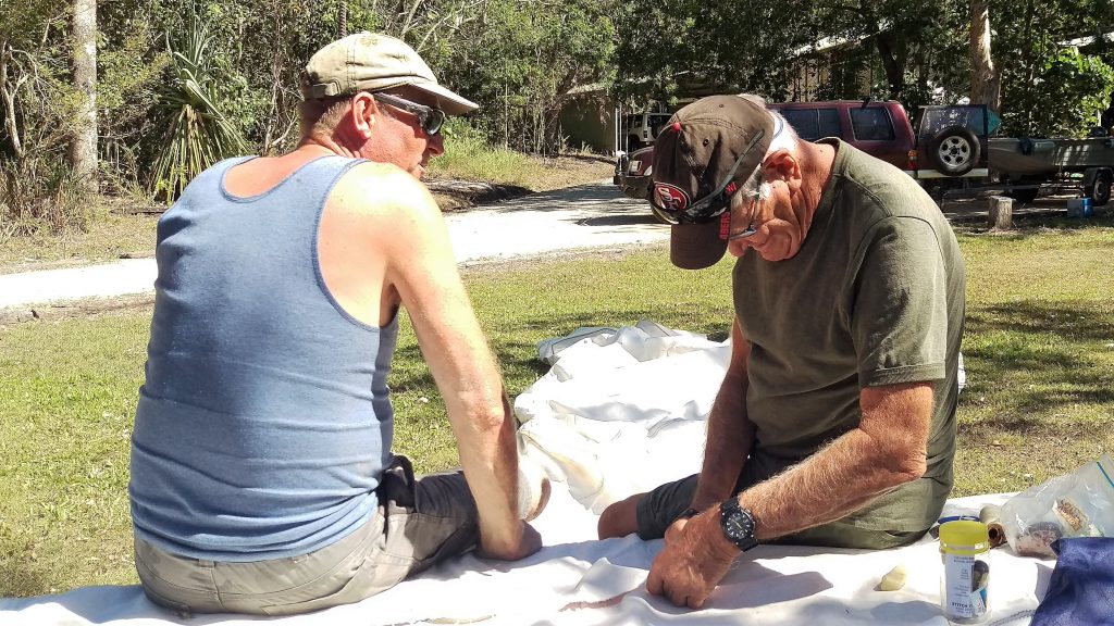 Simon and Andrew sewing up the rip in our main sail. We ripped it when we had engine trouble near Yamba in NSW.